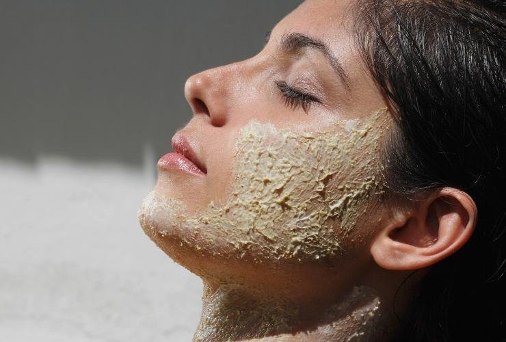 ragazza di profilo con scrub sul viso